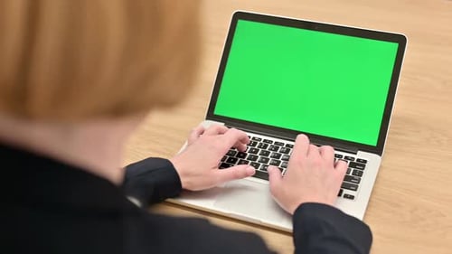 Adult Types on Laptop with Green Screen