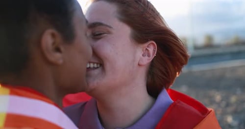 Loving Couple Embraces with Pride Flag