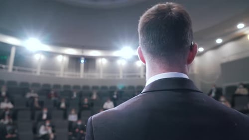 Man Delivers Speech to Corporate Audience