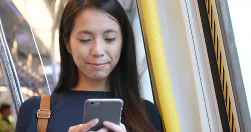 Woman Uses Cellphone on Public Transportation