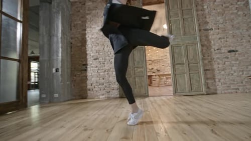 Graceful Woman Dancing in a Sunny Loft Apartment
