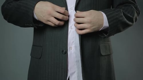 Self-Confident Businessman Buttoning His Suit Jacket Close-Up Formal Wear