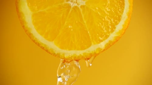 Close Up Shot of Orange Slice with Water