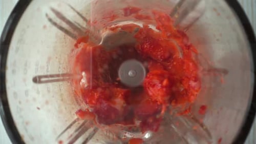 Strawberries Being Blended into a Puree Inside a Blender