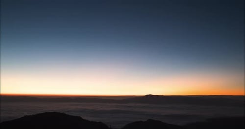 Time Lapse of foggy mountain with sunrise