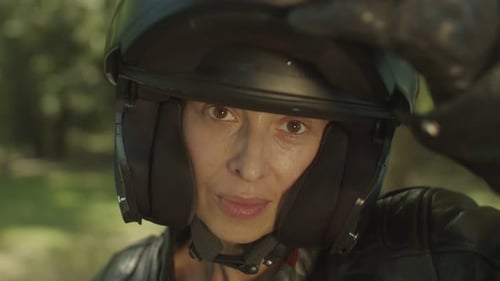 Woman in Motorcycle Helmet Closes Shield