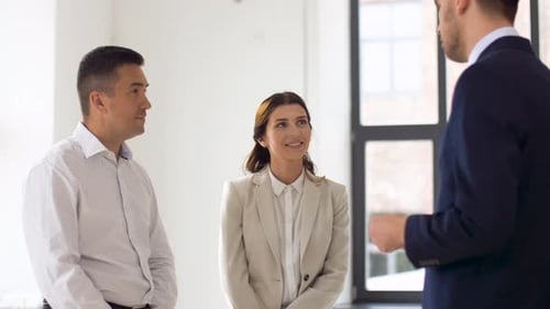 Realtor Giving Key To Customers at New Office