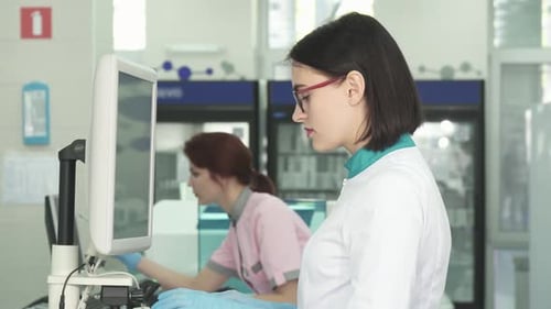 Lab Workers Operating Computers in Modern Lab