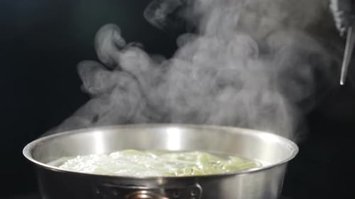 Green Pasta Cooking in a Steaming Pot