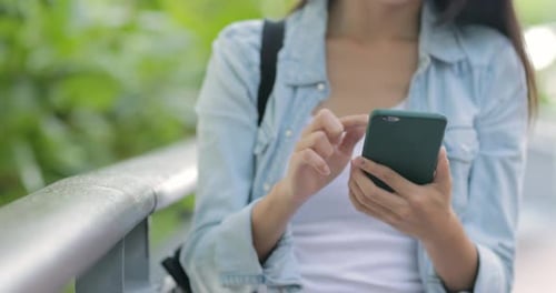 Woman using mobile phone in the park