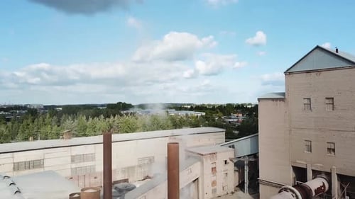 Small factory with smoking chimneys