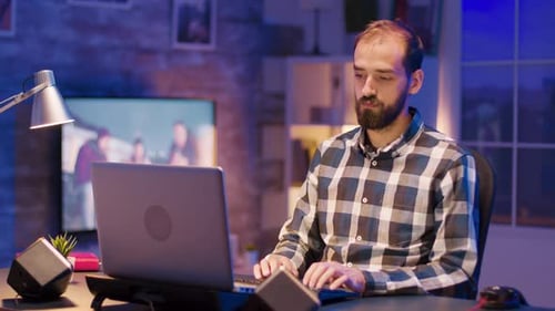 Müder junger Freelancer arbeitet spät in der Nacht auf dem Laptop von zu Hause