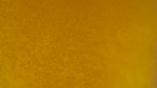 Bubbles Rising in Light Yellow Beer