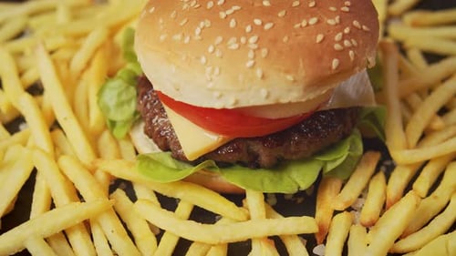 Burger with Cheese, Tomato, and Fries Close Up