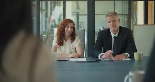 Two business people having a conversation with their business partners about a new project strategy.
