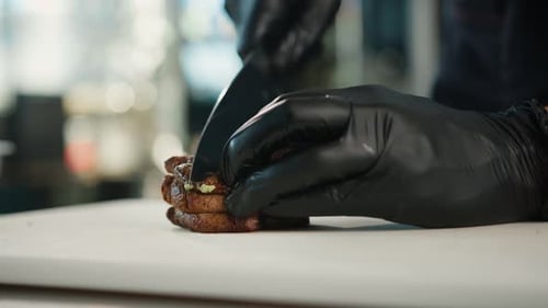 Chef Slicing Grilled Steak in Restaurant Kitchen