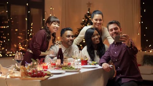 Friends Celebrating Christmas Together Indoors, Taking Selfie