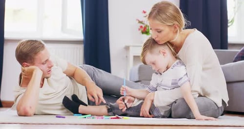 Family Drawing Together with Markers at Home