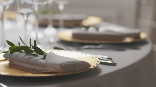 Elegant Table Setting with Golden Plates and Napkins