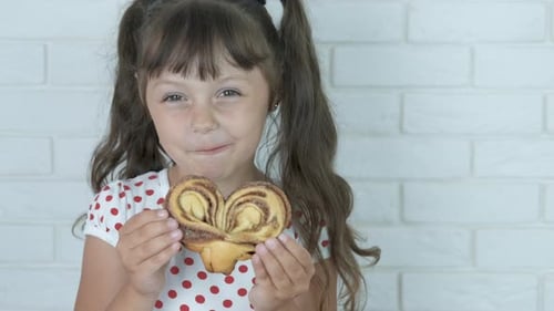 Kid eat home baked sweet.