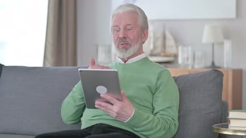 Senior Man Enjoys Video Call on Tablet Device