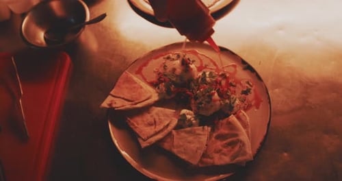 Applying Sauce to a Delicious Pita Bread Dish