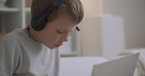 Boy Studying Online with Laptop and Headphones