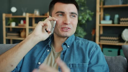 Man Talking on Smartphone in Comfortable Home Setting