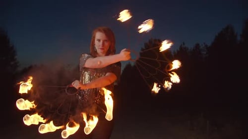 Woman Performing Mesmerizing Fire Dance at Night