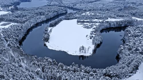 River and snowy forest in winter. Aerial view of wildlife