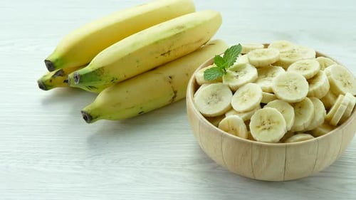 Bananas and Sliced Bananas in a Bowl