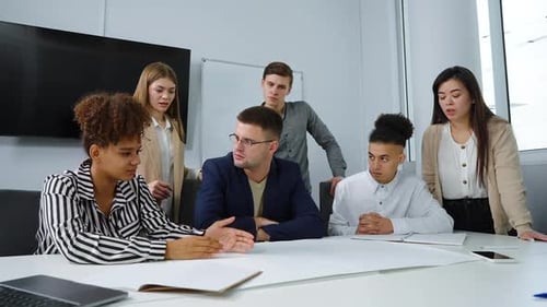 Group of Designers Discussing Scheme in Office