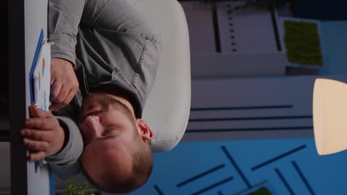 Exhausted Overworked Businessman Sleeping on Desk Table in Startup Business Office