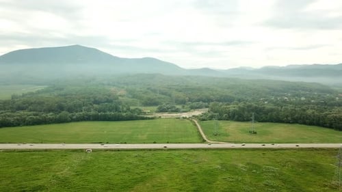 Aerial View of Sunset with Fog Above Forest and Mountains