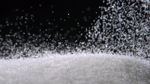 Pile of sugar on black background, Slow Motion