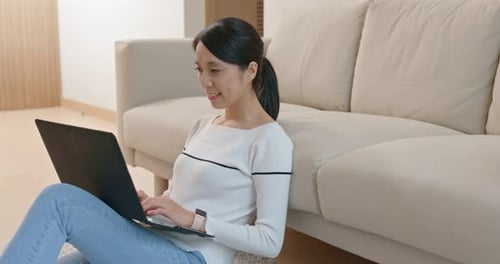 Woman Working on Laptop in Living Room