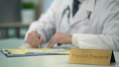 Physical Therapist Writing Prescription, Completing Documentation in Office