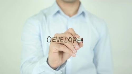 Man Writes 'Developer' on Transparent Surface