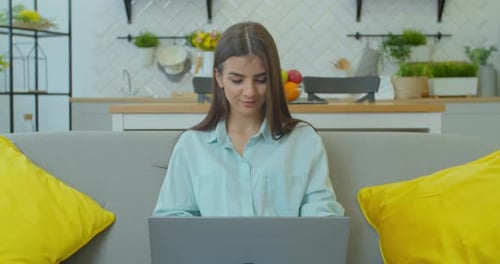 Woman Using Laptop at Home During the Day