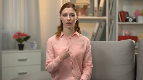 Woman Using Sign Language in a Home Setting