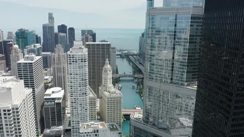 Bridges Over Chicago River Drone Flying Backwards Between Skyscrapers USA