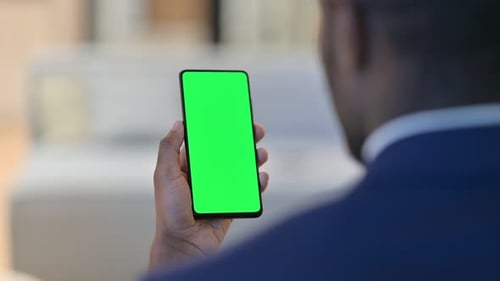 Adult Holding Mobile Phone With Green Screen