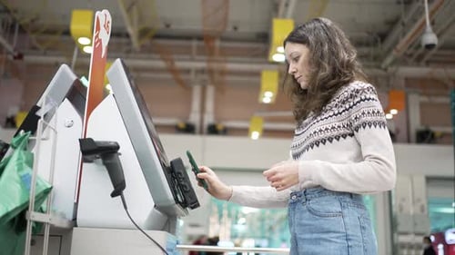 Brunette Woman Pays at Selfcheckout Point and Gets Receipt