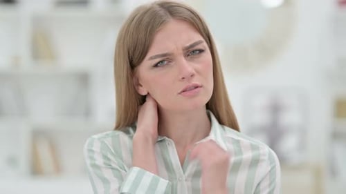 Young Woman Massaging Stiff Neck Muscles