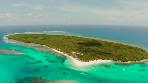 Tropical Daco Island with a Sandy Beach and Tourists.