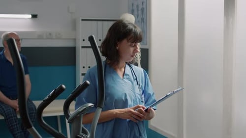 Healthcare Worker Holds Clipboard in Therapy Setting
