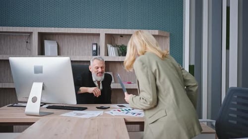 Colleagues Reviewing Business Data at Office Desk
