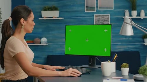 Woman Working at Computer with Green Screen