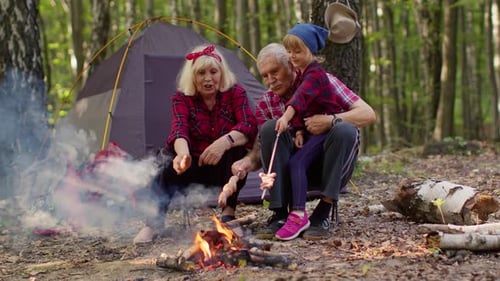 Grandparents and Grandchild Camping, Roasting Sausages