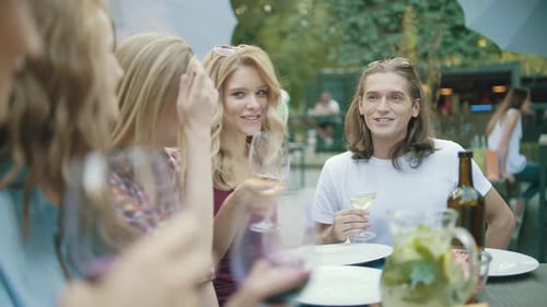 Friends Enjoying Lunch Together at Outdoor Restaurant
